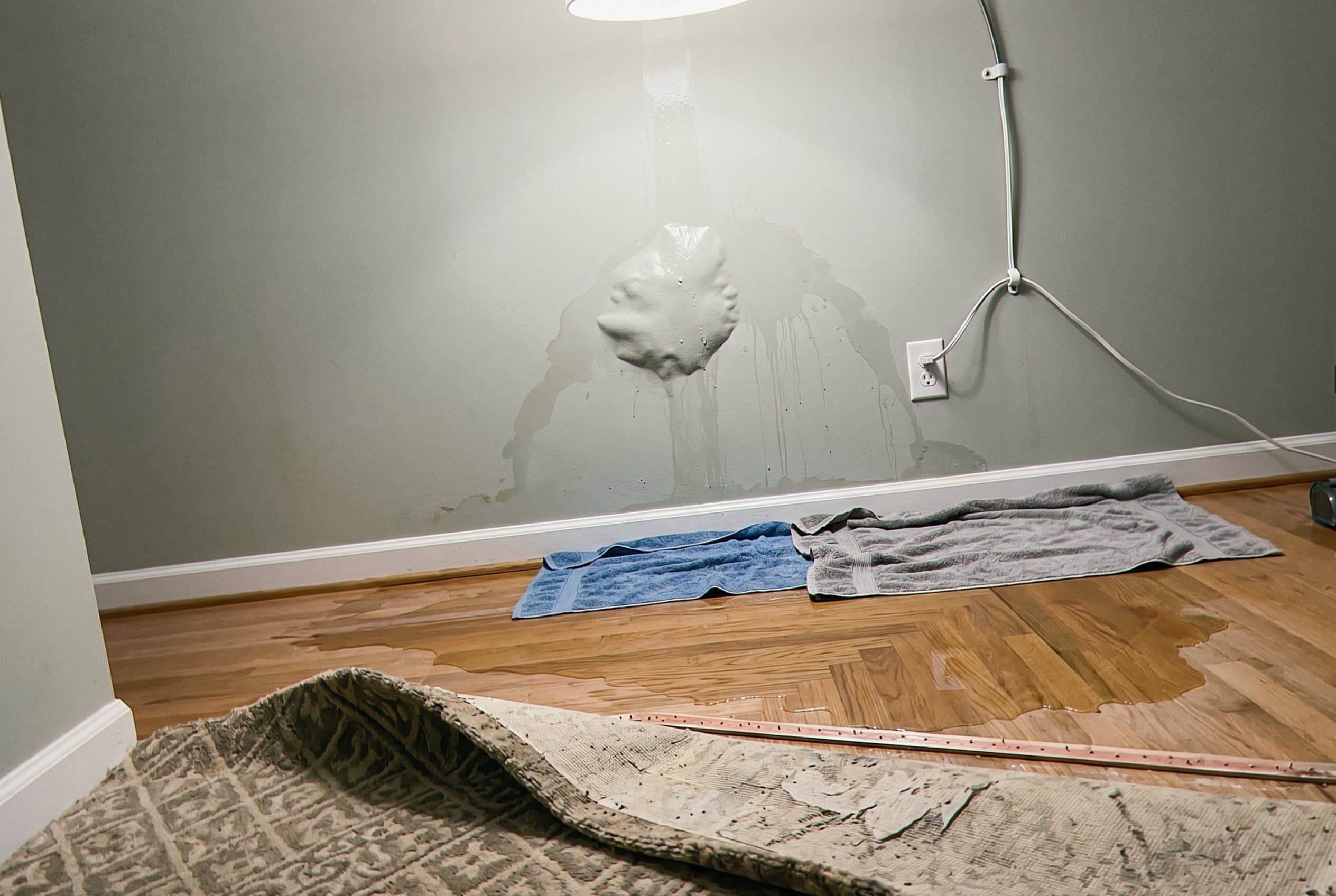 Kitchen water damage visible on floor